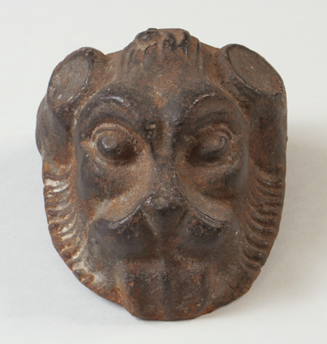 A cast iron lion's head sculpture, featuring detailed facial features and a textured surface, dating from 1850 to 1899.
