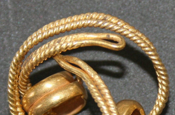 Close-up of a finely twisted gold Bronze Age bracelet, featuring intricate design details.