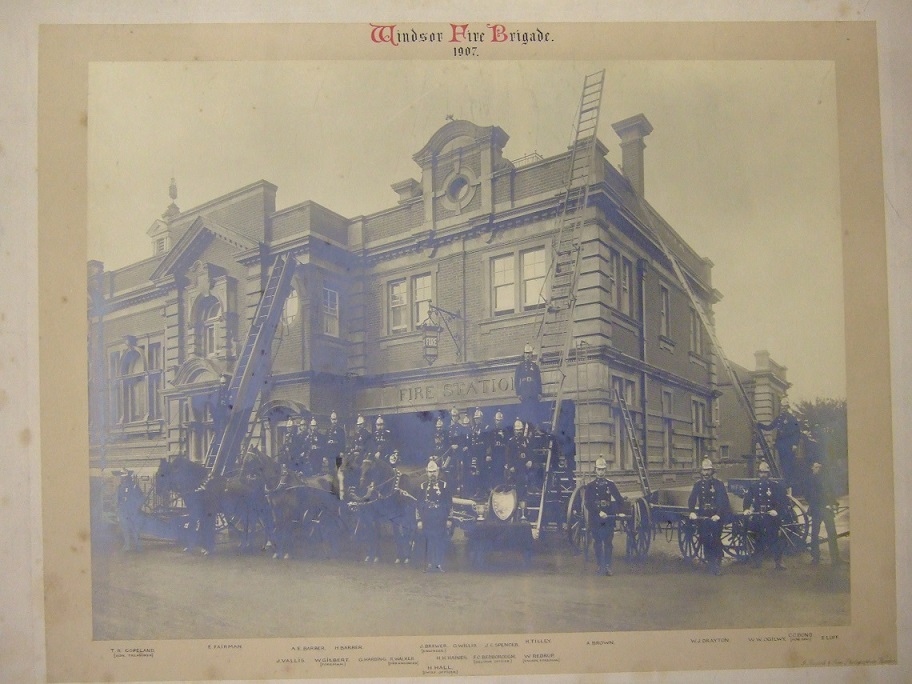 Historic 1907 photograph of the Windsor Fire Brigade in front of the fire station, featuring firefighters, horses, and firefighting equipment.