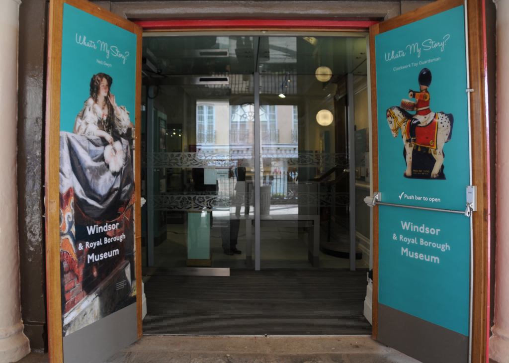 Entrance of the Windsor & Royal Borough Museum featuring colorful signage and images promoting the museum.