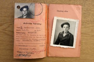 Historic document featuring a travel pass with photographs of a young Jewish boy, issued after World War II, highlighting the experiences of Holocaust survivors.