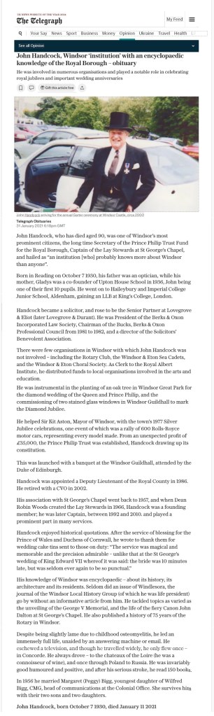 John Handcock in a more formal portrait being well-dressed wearing a top hat and tails, standing beside a car, smiling at the camera.