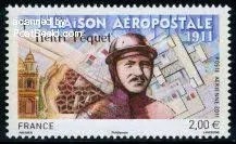 A commemorative stamp featuring Henri Péquet, depicting him in pilot gear with an illustration of a plane and architectural details in the background, celebrating his contribution to airmail in 1911.