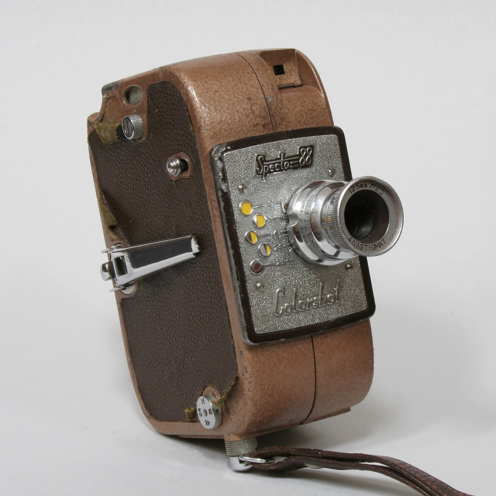 Vintage Specto 88 color film camera with a leather covering and a silver lens.